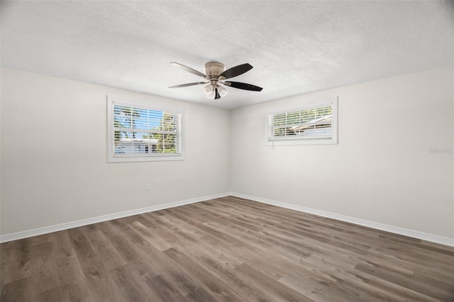 5122 Chet Dr, New Port Richey, FL 34652 - spare room with wood finished floors, a textured ceiling, a ceiling fan, and baseboards