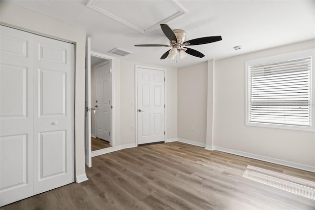5122 Chet Dr, New Port Richey, FL 34652 - unfurnished bedroom featuring wood finished floors, baseboards, and a ceiling fan