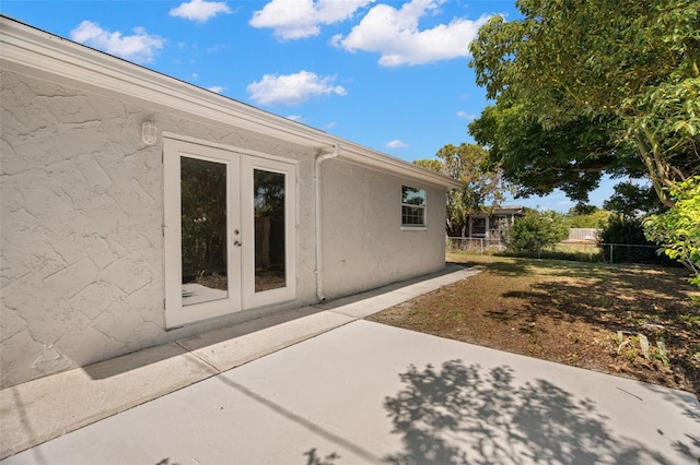 5122 Chet Dr, New Port Richey, FL 34652 - view of side of home featuring french doors, a patio area, and stucco siding
