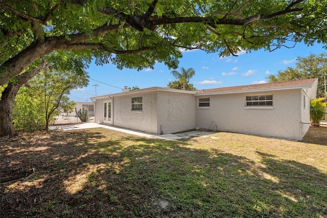 5122 Chet Dr, New Port Richey, FL 34652 - back of property featuring stucco siding, a patio area, and a yard
