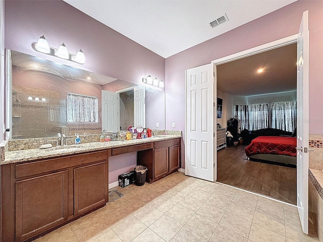 4916 Rolling Green Dr, Wesley Chapel, FL 33543 - full bathroom with double vanity, tile patterned floors, tiled shower, and ensuite bathroom