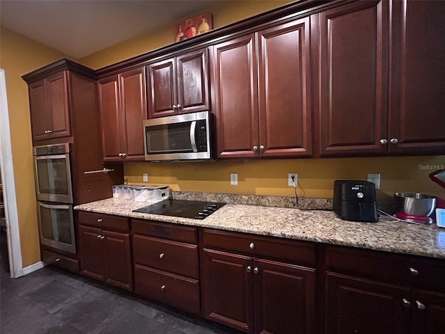 4916 Rolling Green Dr, Wesley Chapel, FL 33543 - kitchen with appliances with stainless steel finishes, baseboards, dark brown cabinetry, and light stone countertops