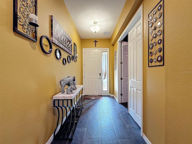 4916 Rolling Green Dr, Wesley Chapel, FL 33543 - entrance foyer featuring a textured wall, a textured ceiling, and baseboards