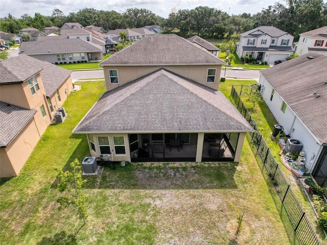 4916 Rolling Green Dr, Wesley Chapel, FL 33543 - back of house with roof with shingles, a residential view, a sunroom, central AC unit, and stucco siding