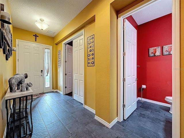 4916 Rolling Green Dr, Wesley Chapel, FL 33543 - foyer featuring baseboards and a textured ceiling