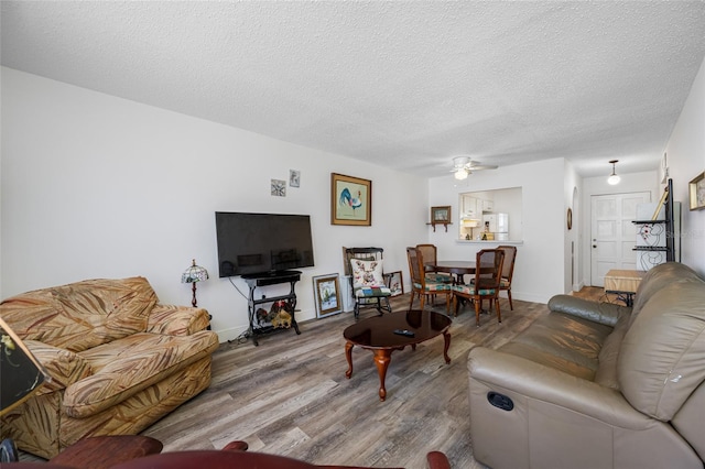 2928 Feather Dr, Clearwater, FL 33759 - living room featuring wood finished floors, a textured ceiling, ceiling fan, and baseboards