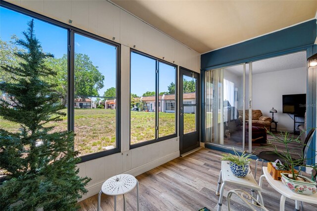 2928 Feather Dr, Clearwater, FL 33759 - sunroom / solarium with wood finished floors, plenty of natural light, and baseboards