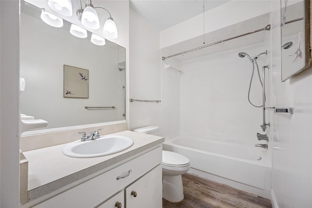 2928 Feather Dr, Clearwater, FL 33759 - bathroom featuring toilet, vanity, bathtub / shower combination, and wood finished floors