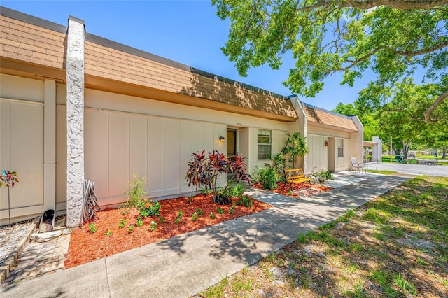 2928 Feather Dr, Clearwater, FL 33759 - view of front of house with mansard roof and a shingled roof