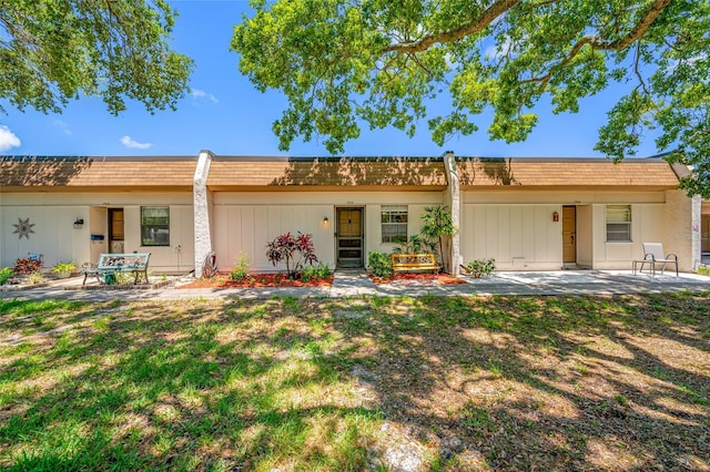 2928 Feather Dr, Clearwater, FL 33759 - rear view of property with a patio and mansard roof