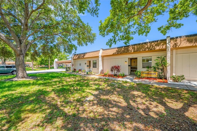 2928 Feather Dr, Clearwater, FL 33759 - view of front of house featuring a front lawn and mansard roof