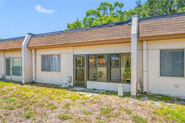 2928 Feather Dr, Clearwater, FL 33759 - rear view of property featuring mansard roof and roof with shingles