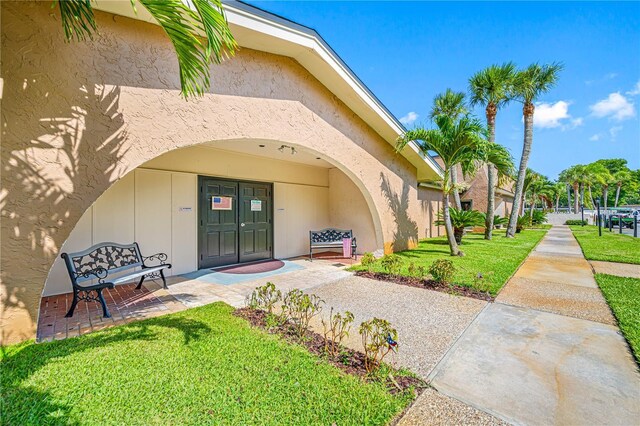 2928 Feather Dr, Clearwater, FL 33759 - entrance to property with a lawn and stucco siding