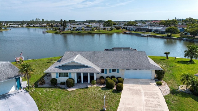 1009 Andover Cir, Sun City Center, FL 33573 - view of front of home featuring concrete driveway, a water view, an attached garage, a front lawn, and roof with shingles
