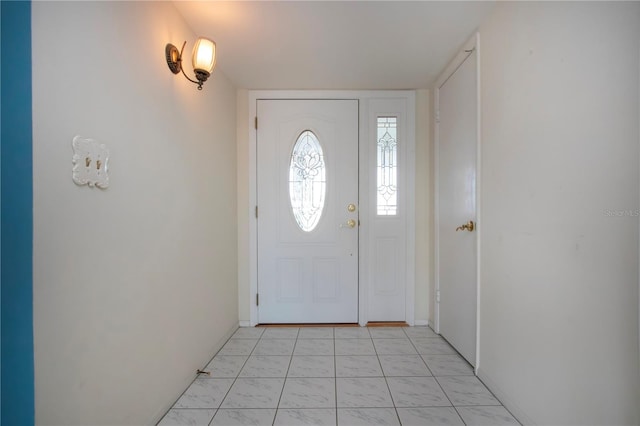 1009 Andover Cir, Sun City Center, FL 33573 - foyer with light marble finish floors and baseboards