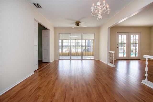 1009 Andover Cir, Sun City Center, FL 33573 - spare room featuring healthy amount of natural light, ceiling fan, a chandelier, and wood finished floors