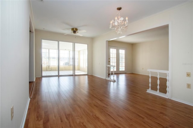 1009 Andover Cir, Sun City Center, FL 33573 - empty room featuring wood finished floors, crown molding, a chandelier, ceiling fan, and baseboards