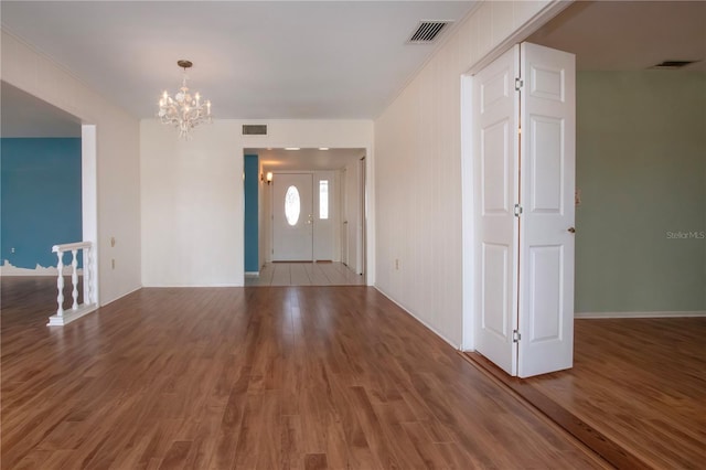 1009 Andover Cir, Sun City Center, FL 33573 - entrance foyer with a chandelier, wood finished floors, ornamental molding, and baseboards
