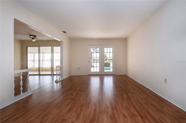 1009 Andover Cir, Sun City Center, FL 33573 - unfurnished room featuring healthy amount of natural light, ceiling fan, wood finished floors, and baseboards
