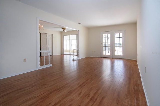 1009 Andover Cir, Sun City Center, FL 33573 - empty room featuring wood finished floors, a ceiling fan, and baseboards