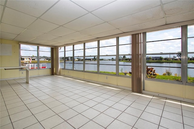 1009 Andover Cir, Sun City Center, FL 33573 - unfurnished sunroom featuring a water view, a drop ceiling, and tile patterned floors