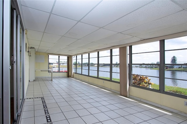 1009 Andover Cir, Sun City Center, FL 33573 - unfurnished sunroom featuring a water view, a drop ceiling, and tile patterned flooring