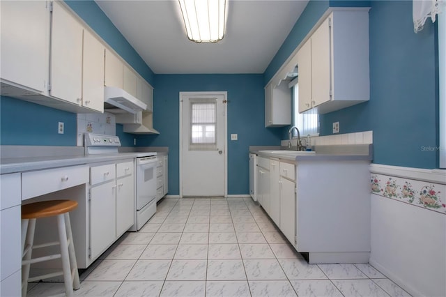 1009 Andover Cir, Sun City Center, FL 33573 - kitchen featuring white electric stove, under cabinet range hood, light countertops, light marble finish floors, and a sink