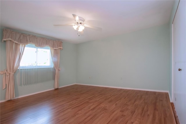 1009 Andover Cir, Sun City Center, FL 33573 - empty room featuring wood finished floors, ceiling fan, and baseboards