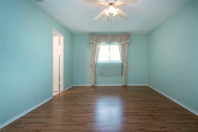 1009 Andover Cir, Sun City Center, FL 33573 - spare room featuring a ceiling fan, wood finished floors, and baseboards