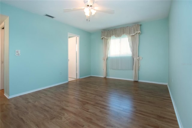1009 Andover Cir, Sun City Center, FL 33573 - unfurnished room with a ceiling fan, wood finished floors, and baseboards