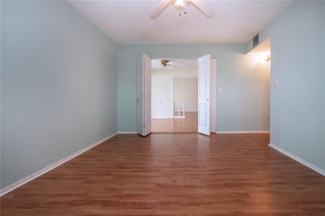 1009 Andover Cir, Sun City Center, FL 33573 - empty room featuring ceiling fan, wood finished floors, and baseboards
