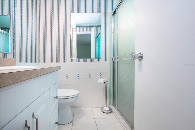 1009 Andover Cir, Sun City Center, FL 33573 - bathroom with toilet, a shower stall, tile patterned floors, vanity, and wallpapered walls