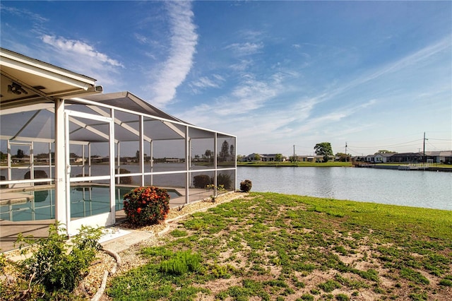 1009 Andover Cir, Sun City Center, FL 33573 - view of grassy yard with an outdoor pool, a water view, a patio area, and glass enclosure