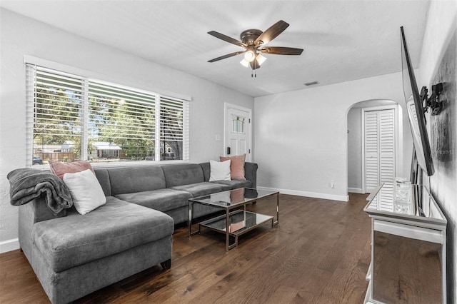 4531 7th Ave N, Saint Petersburg, FL 33713 - living area featuring arched walkways, a ceiling fan, dark wood-style floors, and baseboards