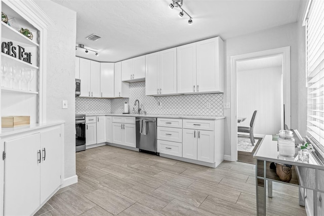 4531 7th Ave N, Saint Petersburg, FL 33713 - kitchen with appliances with stainless steel finishes, track lighting, light countertops, and white cabinets