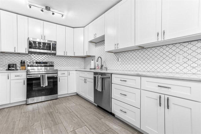4531 7th Ave N, Saint Petersburg, FL 33713 - kitchen with stainless steel appliances, light countertops, a sink, and backsplash