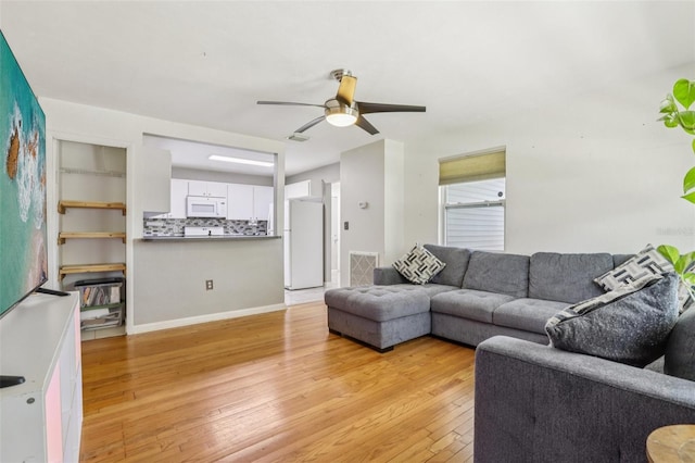 1015 13th Ave NW, Largo, FL 33770 - living room featuring light wood finished floors and ceiling fan