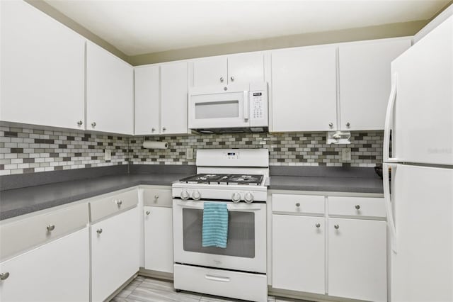1015 13th Ave NW, Largo, FL 33770 - kitchen with white appliances, dark countertops, and white cabinetry