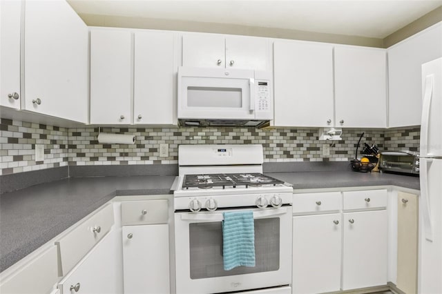 1015 13th Ave NW, Largo, FL 33770 - kitchen with white appliances, dark countertops, and white cabinetry