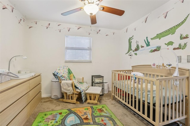 1015 13th Ave NW, Largo, FL 33770 - bedroom with light colored carpet, a nursery area, and a ceiling fan