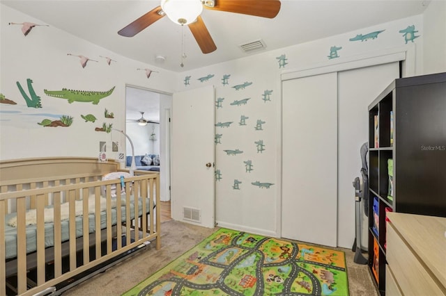 1015 13th Ave NW, Largo, FL 33770 - carpeted bedroom with a closet, a nursery area, and a ceiling fan