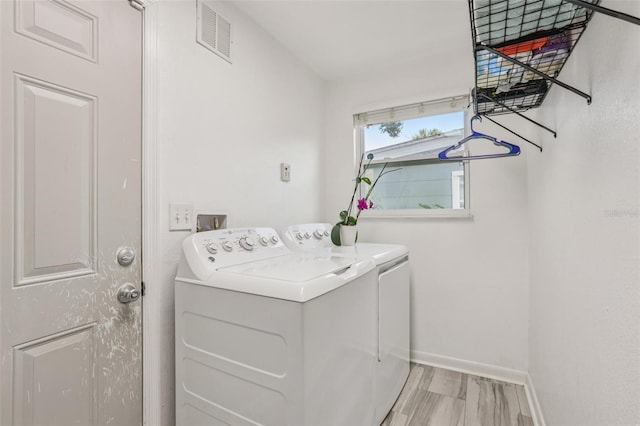 1015 13th Ave NW, Largo, FL 33770 - laundry room featuring washer and clothes dryer and baseboards