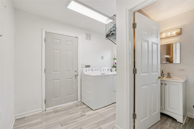 1015 13th Ave NW, Largo, FL 33770 - washroom featuring independent washer and dryer and light wood-style flooring