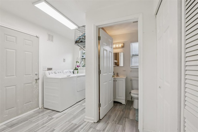 1015 13th Ave NW, Largo, FL 33770 - bathroom featuring vanity, washer and dryer, a closet, and wood finished floors