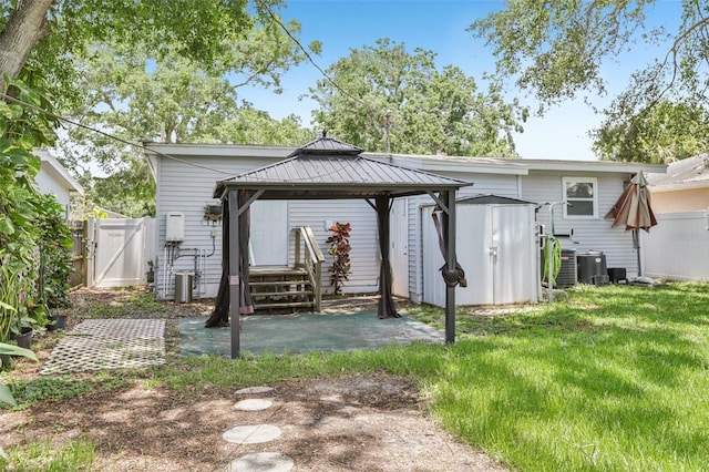 1015 13th Ave NW, Largo, FL 33770 - back of property with a gazebo, a gate, a shed, a patio area, and a standing seam roof