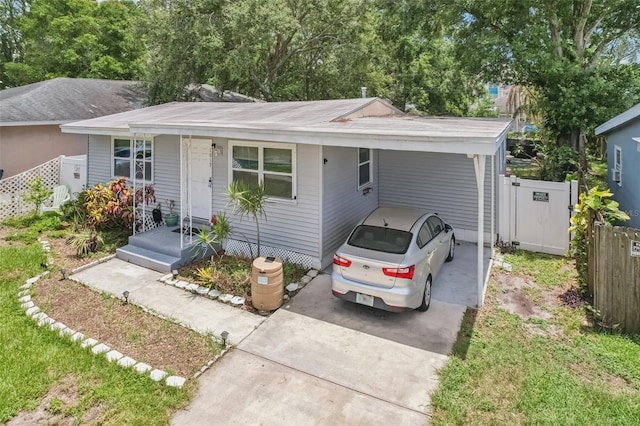 1015 13th Ave NW, Largo, FL 33770 - view of front facade with driveway and a carport