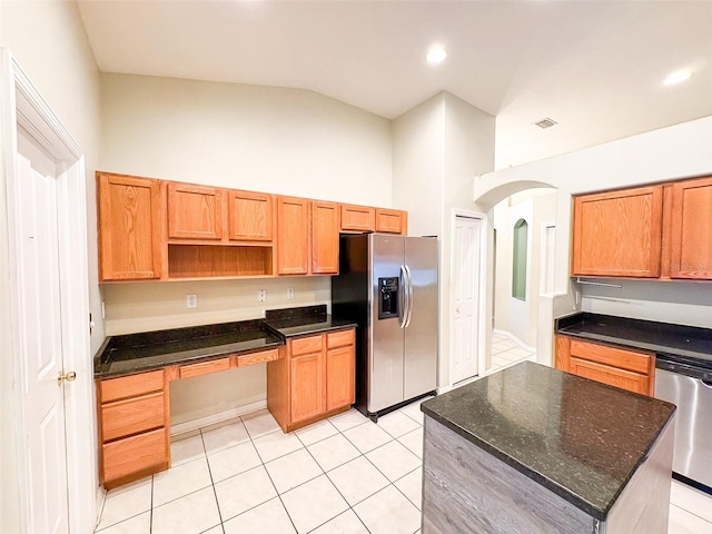 9735 Riverchase Dr, New Port Richey, FL 34655 - kitchen featuring stainless steel appliances, light tile patterned floors, high vaulted ceiling, arched walkways, and open shelves