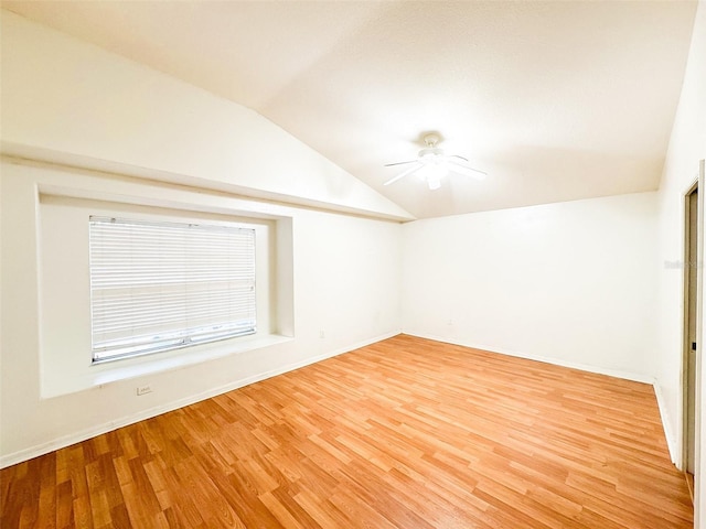 9735 Riverchase Dr, New Port Richey, FL 34655 - unfurnished room with lofted ceiling, light wood-type flooring, a ceiling fan, and baseboards