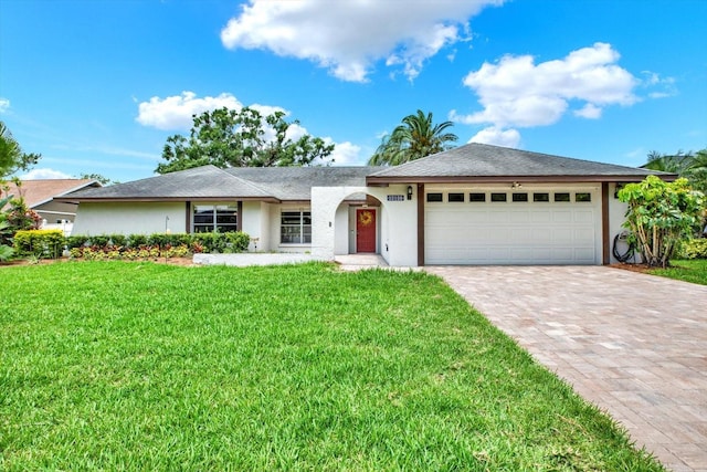 15108 Springview St, Tampa, FL 33624 - ranch-style house featuring stucco siding, a front lawn, a garage, and driveway