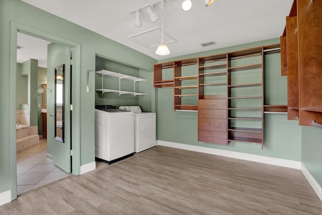 15108 Springview St, Tampa, FL 33624 - laundry room featuring washer and dryer, wood finished floors, and baseboards